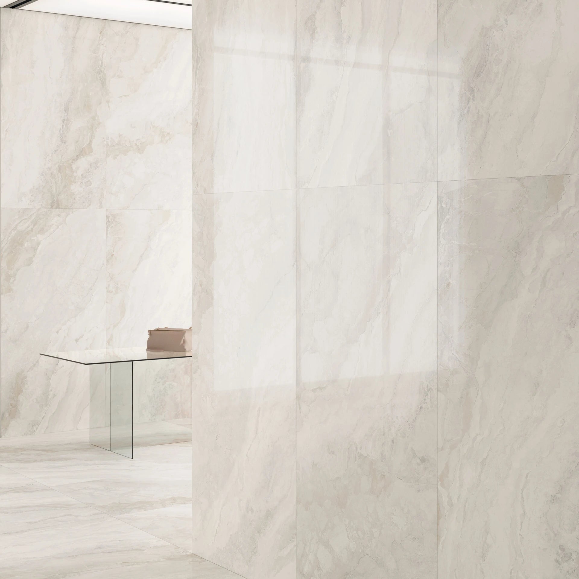 Light beige marble tiles with a subtle pattern on a white background